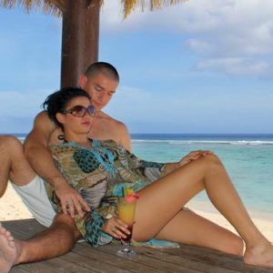 Couple Relaxing On Deck Crown Beach & Spa Resort Rarotonga Cook Island Holidays