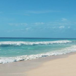 Luxury Mexico Holiday Packages Secrets The Vine Cancun Couple Walking On Beach