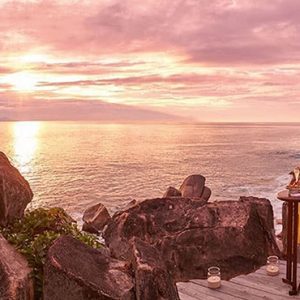 Luxury Seychelle Holiday Packages Constance Lemuria Couple Watching The Sunset With A Glass Of Champagne