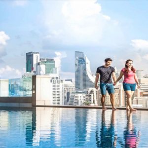 luxury Thailand holiday Packages Rembrandt Hotel Bangkok Couple Walking By Pool