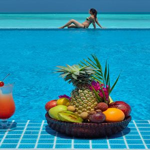 Atmosphere Kanifushi Luxury Maldives Honeymoon Packages Women By The Pool