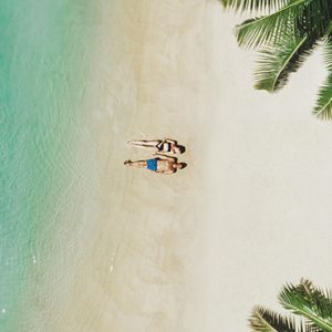 Luxury Mauritius Holiday Packages Paradise Cove Boutique Hotel Couple Lying Down On The Cove Beach