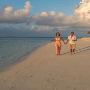Furaveri Island Resort - Luxury Maldives Holiday Packages - couple on beach