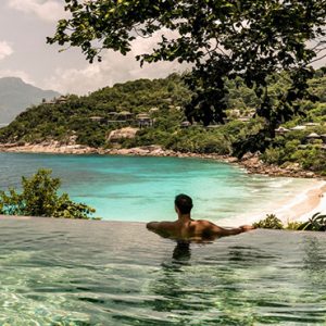 Four Seasons Resort Seychelles Luxury Seychelles holiday Packages Man In Pool