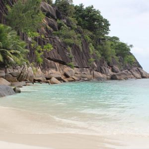 Four Seasons Resort Seychelles Luxury Seychelles holiday Packages Man Strolling On Beach