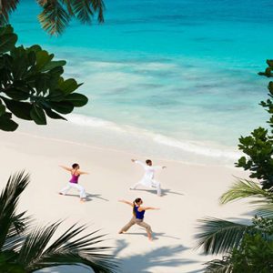 Four Seasons Resort Seychelles Luxury Seychelles holiday Packages Yoga On Beach