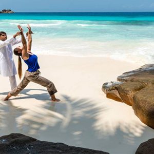 Four Seasons Resort Seychelles Luxury Seychelles holiday Packages Yoga On Beach1